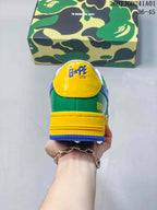 Rear view showing the green heel panel, yellow heel tab, and layered sole