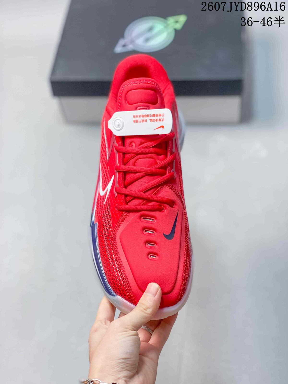 Top view of the red lace-up basketball shoe showing the padded tongue, eyelets and dark contrasting forefoot logo.