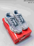 Pair of gray and white Nike P-6000 sneakers displayed on a red shoebox, with style code and advertised size range visible at the top.