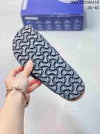 Close-up of the sandal outsole showing a repeating embossed pattern and textured tread.