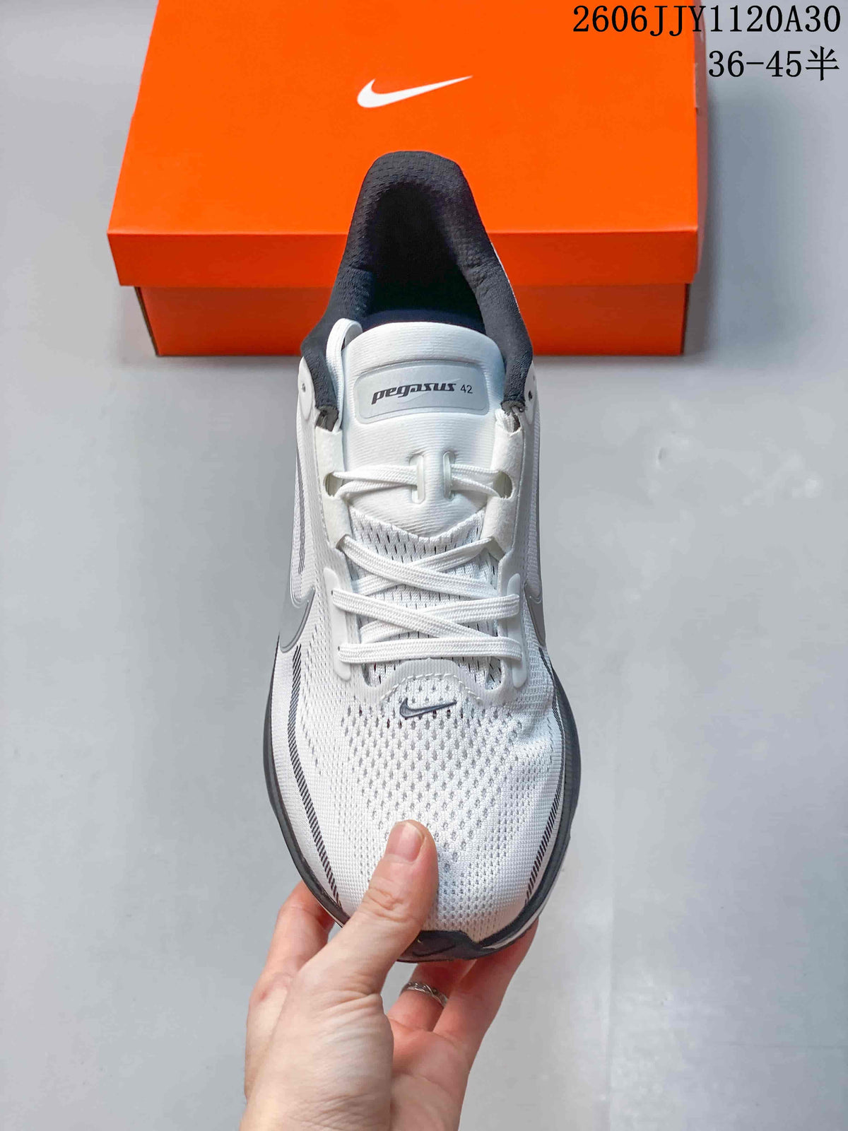 Top view of a white Nike Pegasus 42 shoe with gray details and laces
