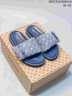 Blue Louis Vuitton Pool Pillow monogram slides displayed on a patterned box; style code and size range are visible at the top.