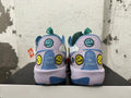 Rear view of multicolor Nike basketball shoes with embroidered smiley faces and lilac heels.