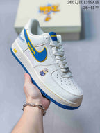 Angled side view showing the white sneaker, blue and yellow accents, Minions graphic and blue outsole.