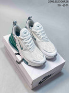 Pair of white and teal Nike Air Max 270 Premium sneakers displayed on a shoebox