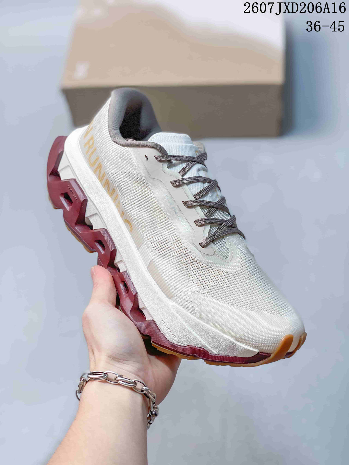 Angled side view of the white running shoe with gray laces, burgundy outsole and gum-colored traction sections.