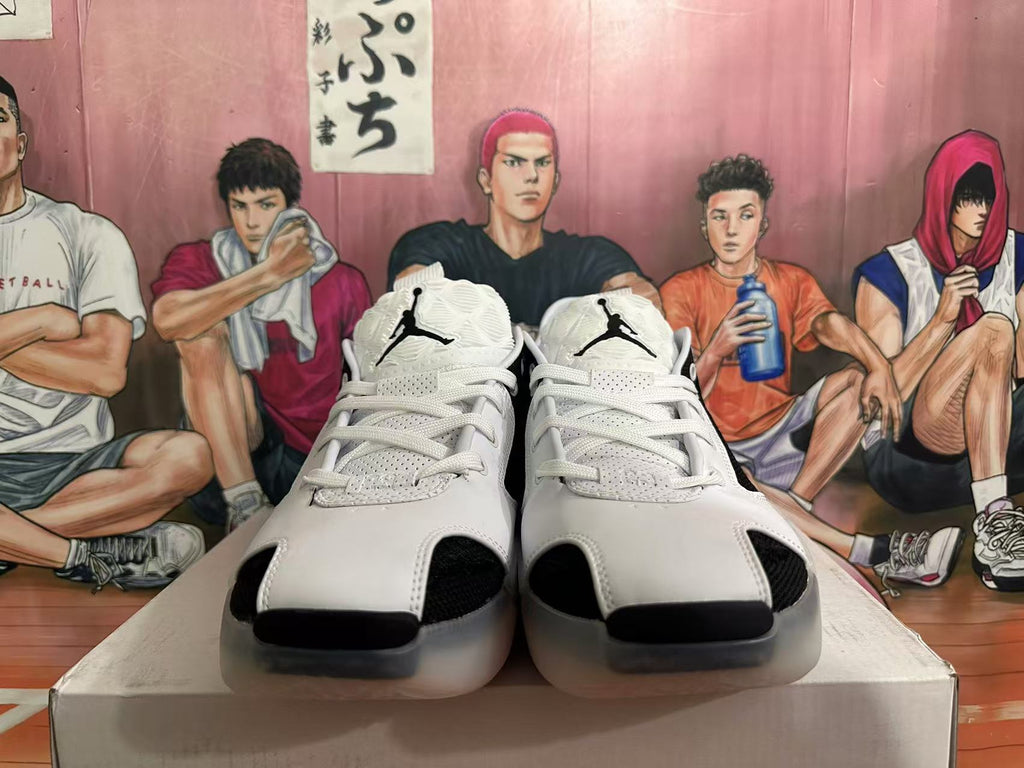 Front view of black and white lace-up Jordan basketball shoes with Jumpman tongue logos.