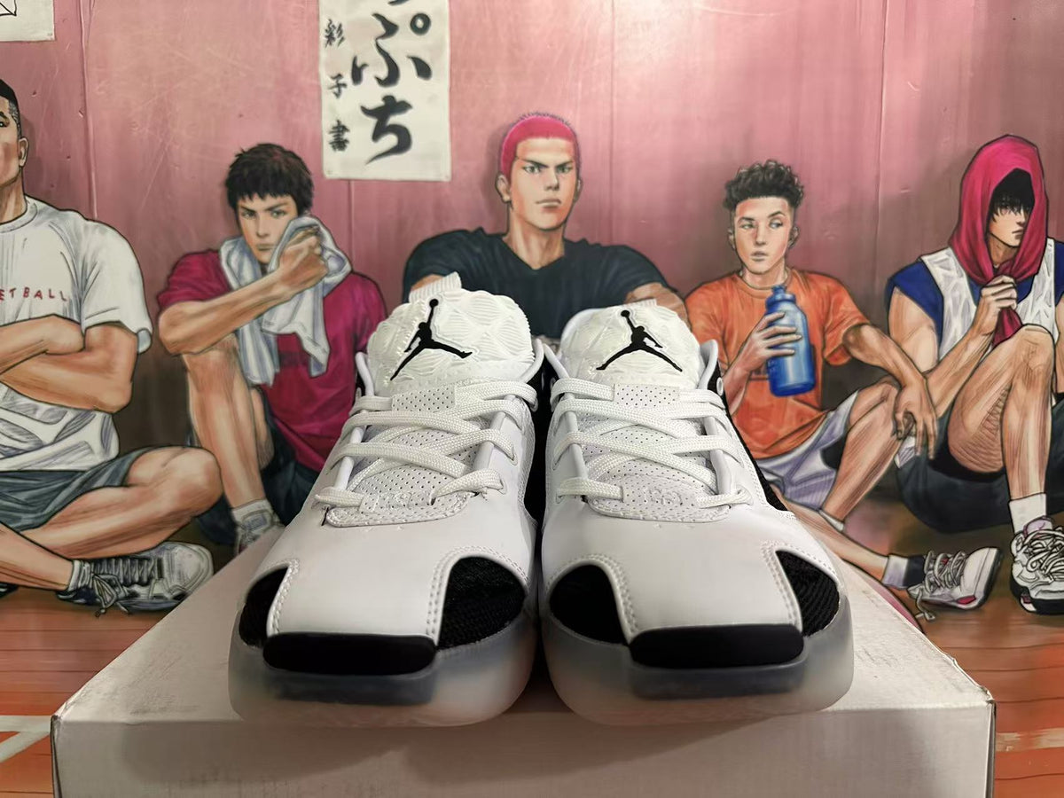 Front view of black and white lace-up Jordan basketball shoes with Jumpman tongue logos.