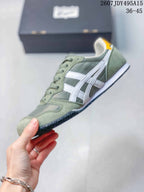 Side view of a green and white Onitsuka Tiger Serrano sneaker showing the contrasting stripes, lace-up construction, and layered sole.