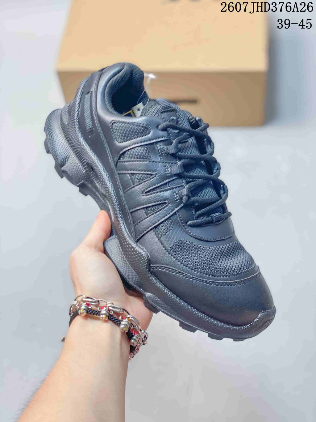 Angled side view of a black ECCO sneaker showing the layered upper, mesh panels, padded collar and textured outsole.