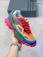 Close-up of a multicolor OZWEEGO sneaker featuring red, green, blue, orange, and gold-toned panels.