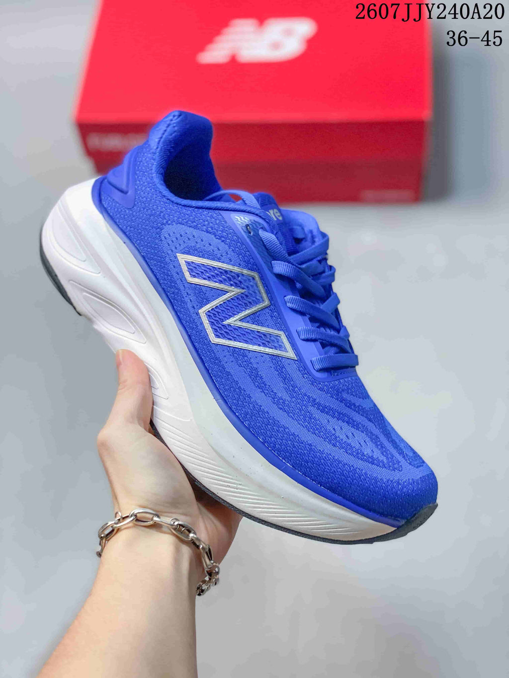 Blue New Balance running sneaker with matching blue upper and branding, paired with a white midsole.