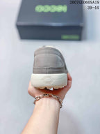 Rear view of the gray sneaker showing the stitched heel and textured light-colored outsole.