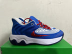Side profile of a white, blue, and red Nike basketball shoe.