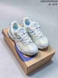 Pair of white ASICS Tiger Gel-Kahana 8 sneakers with blue, yellow and lavender accents displayed on an ASICS shoe box.