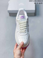 Top view showing the white laces, perforated toe box, and purple tongue branding.