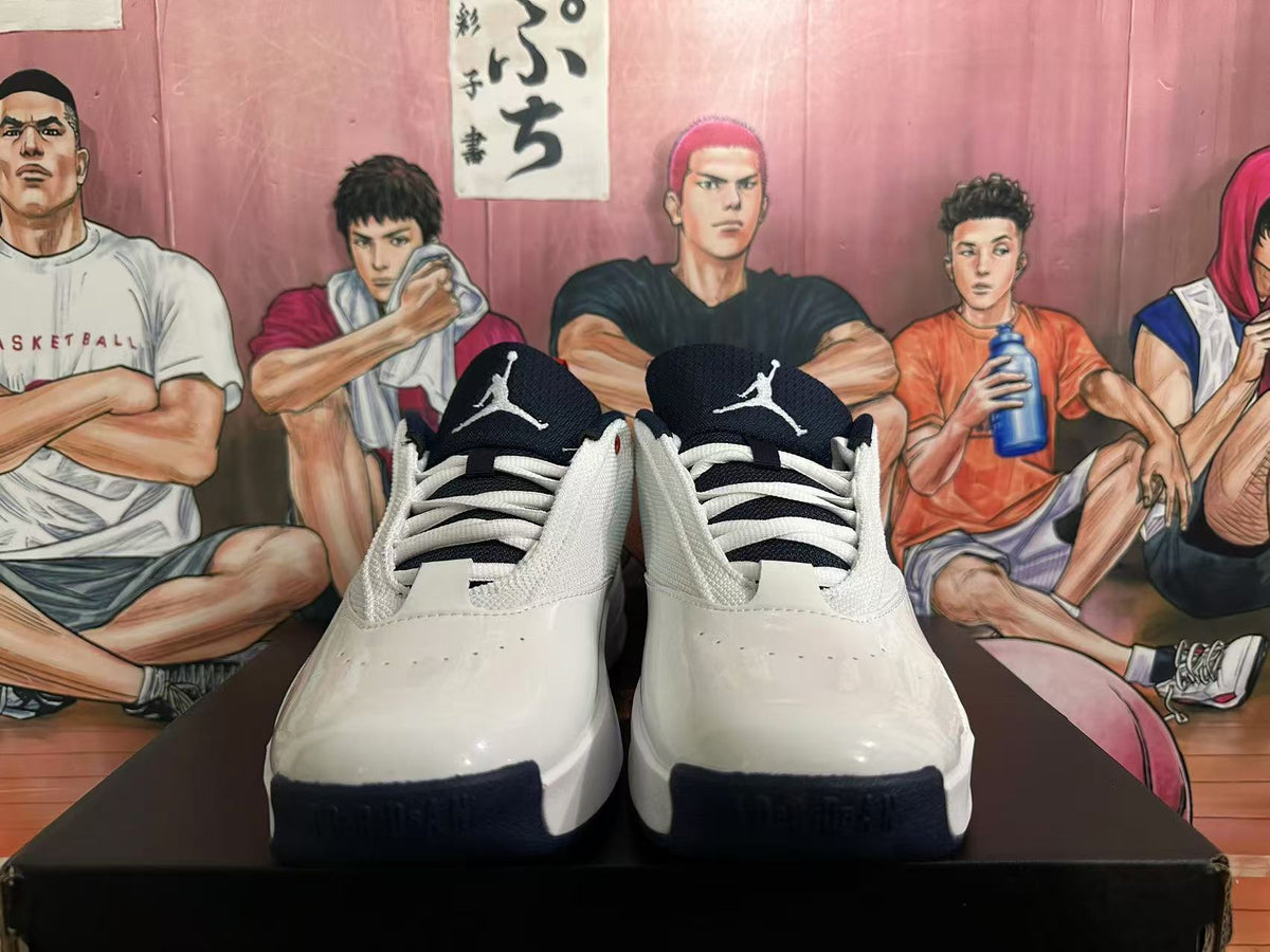 Front view of white Jordan sneakers showing dark blue tongues, white laces, and Jumpman logos.