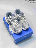 Pair of cream and gray adidas Response CL sneakers displayed on a blue adidas shoe box.