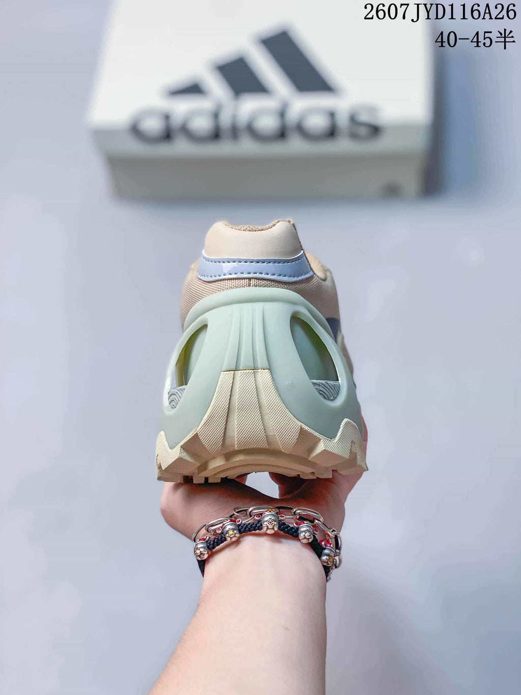 Rear view showing the padded heel collar, mint sculpted heel structure and textured outsole.