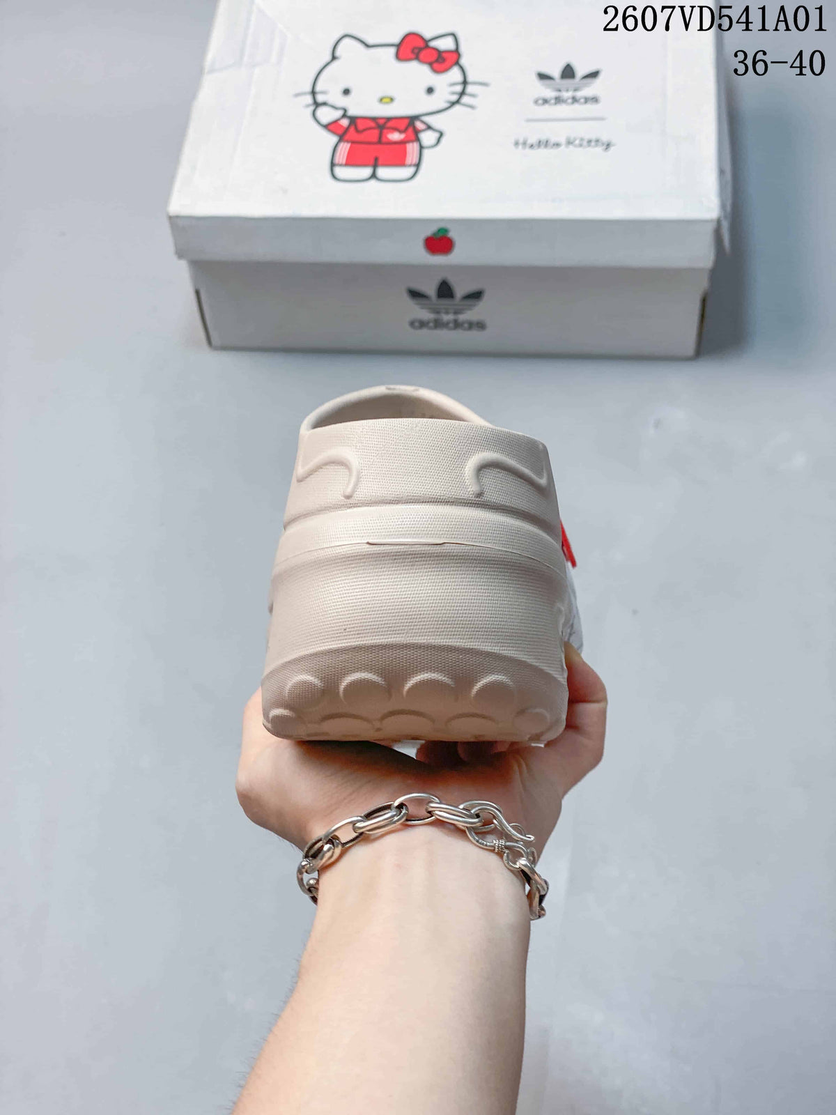 Rear view showing the raised heel and sole of the beige mule clog