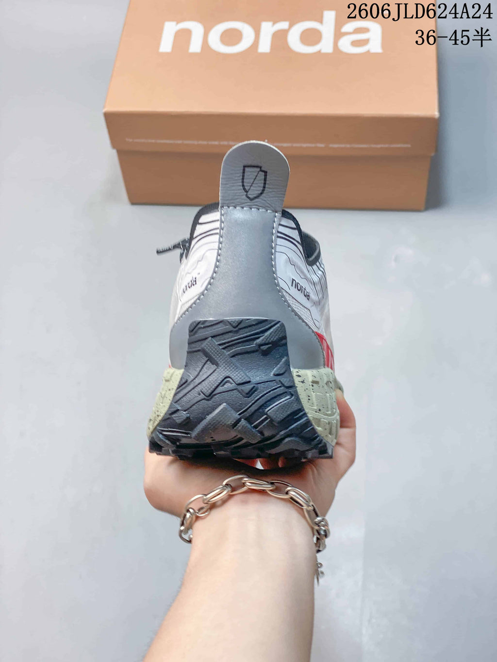 Rear view showing the heel pull tab, outsole, and speckled midsole.