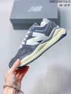 Side profile of the grey and white New Balance 5740 sneaker with its layered panels and cream-colored midsole.