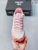 Top view of the pink shoe showing the tongue, woven laces, toe panel, and Arc'teryx branding.