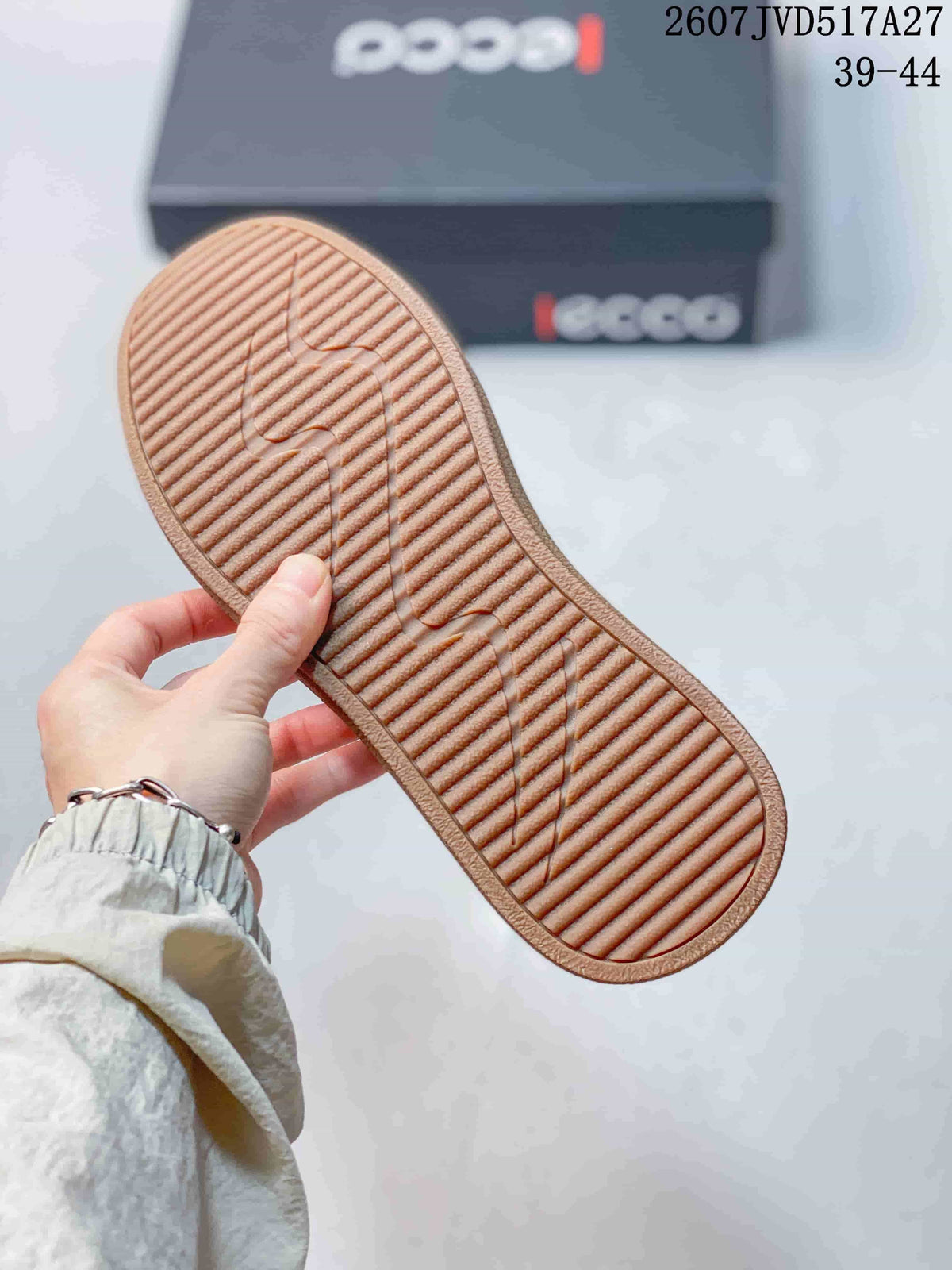 Underside of the sneaker showing the gum-colored ribbed outsole tread.
