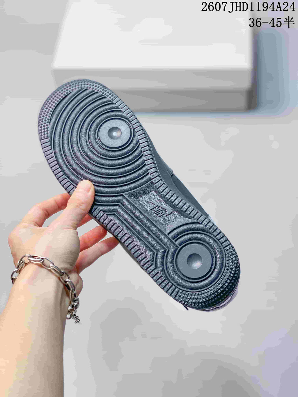Close view of the black outsole showing concentric circular traction zones and textured perimeter tread.