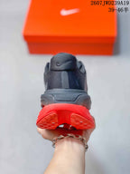 Rear view showing the padded heel, dark upper, and split red outsole design.