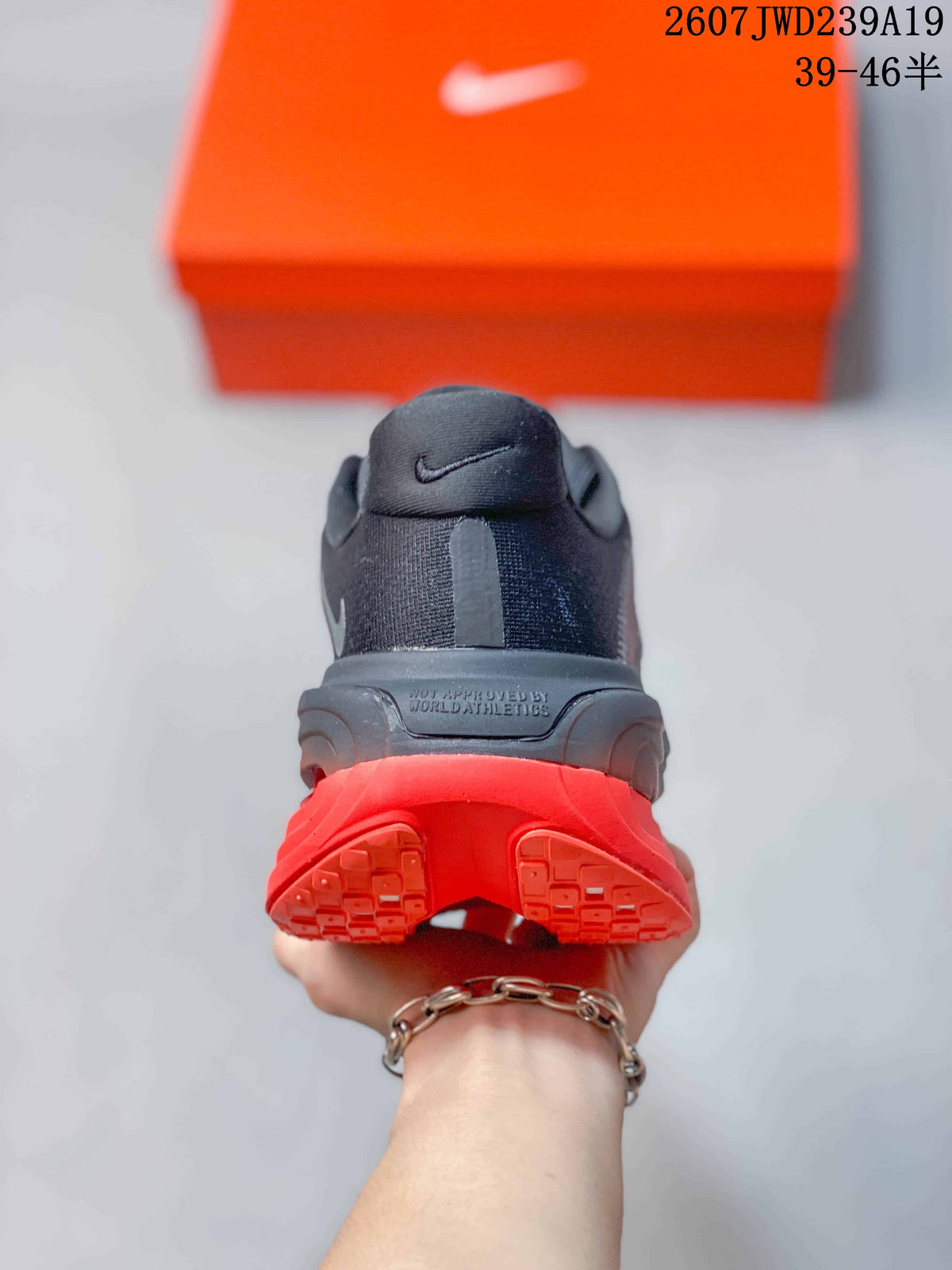 Rear view showing the padded heel, dark upper, and split red outsole design.