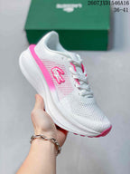 Angled side view of the white and pink sneaker with visible Lacoste branding and pink outsole.