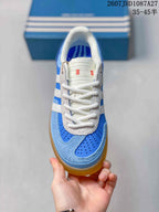 Top view showing the white laces, perforated blue toe panel, and textured overlays.