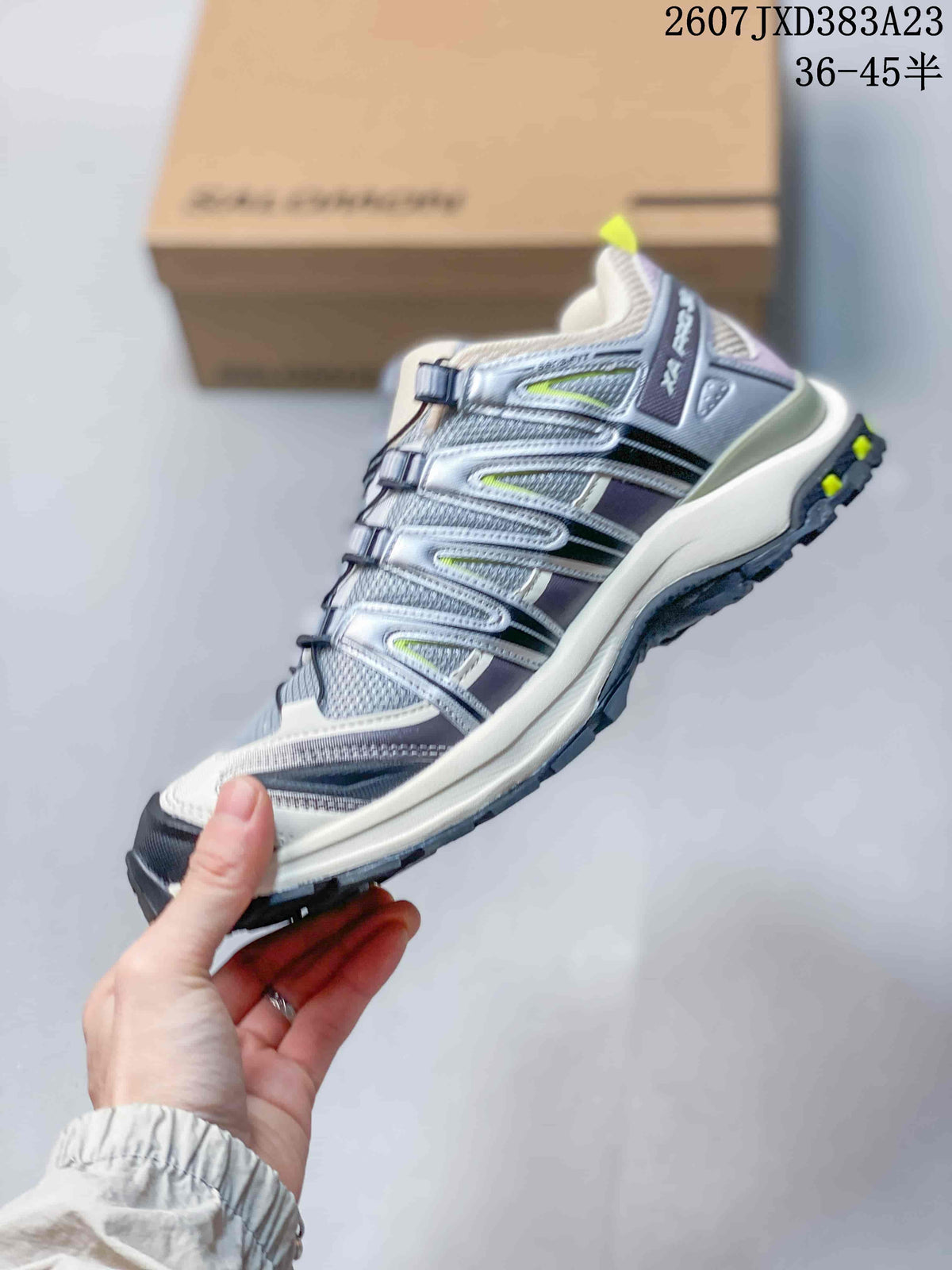 Side profile of the Salomon XA Pro 3D sneaker showing mesh panels, cord fastening, layered overlays, and lugged outsole.