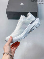 Side view of the white low-top shoe showing the streamlined upper, raised heel section and lugged outsole.