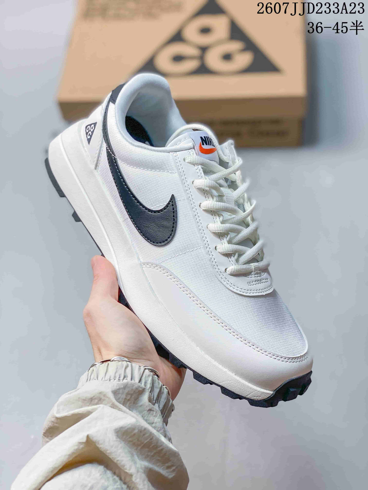 Angled side view showing the white and navy colorway, Nike ACG heel detail, and outsole tread.