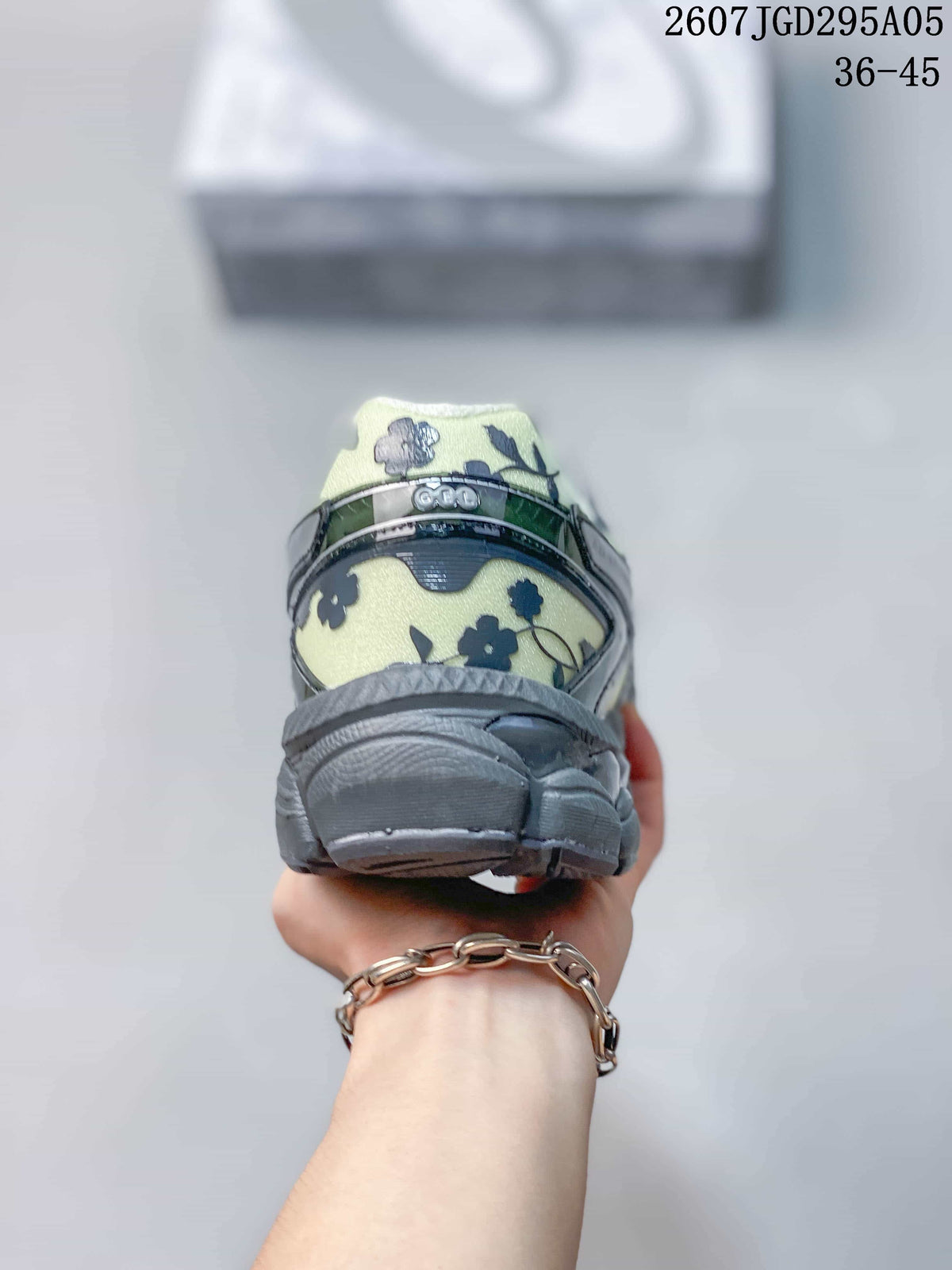 Rear view of the floral ASICS sneaker showing the padded heel collar, heel structure, and outsole.