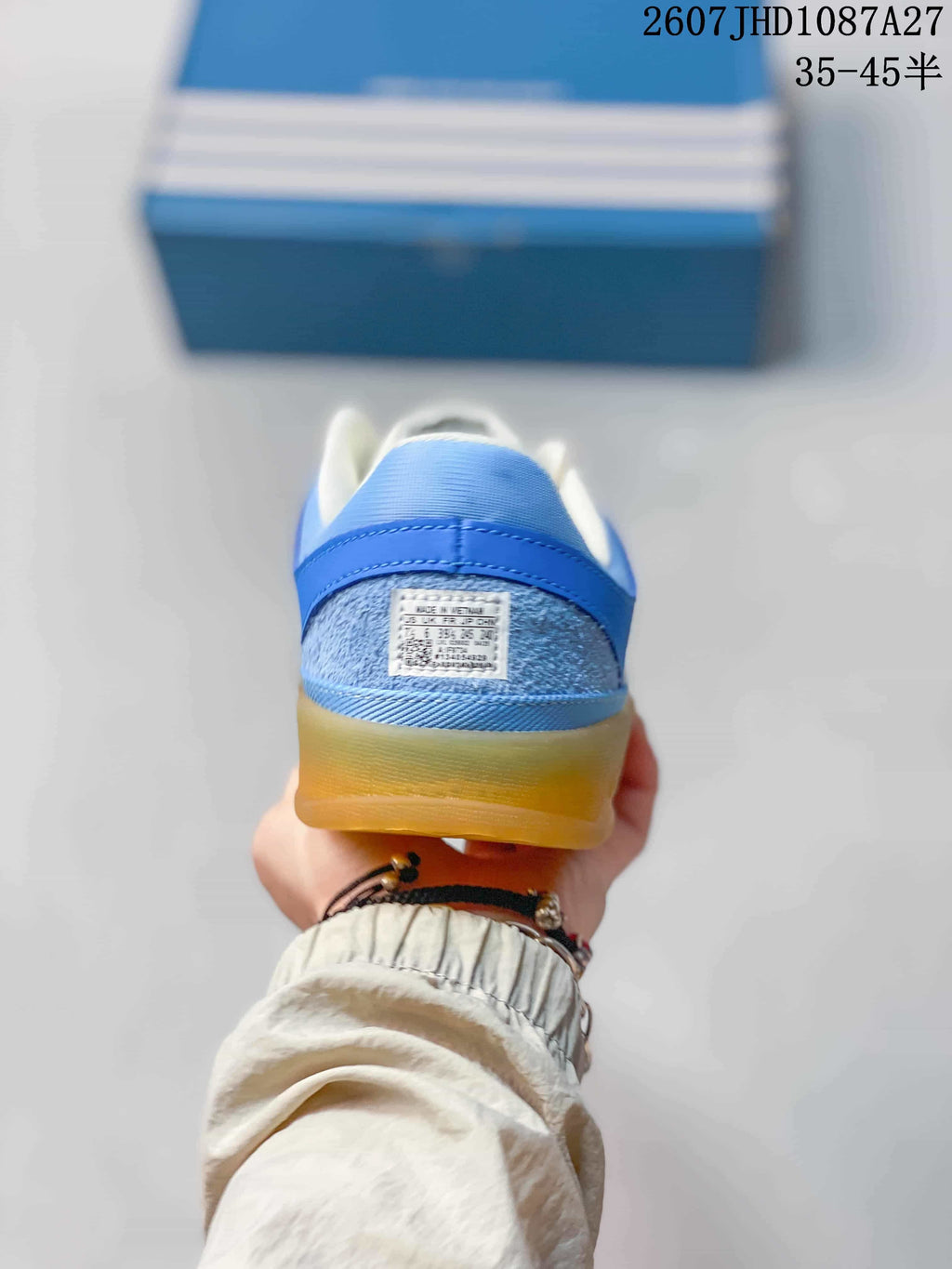 Rear view of the blue heel, padded collar, and gum-colored outsole.