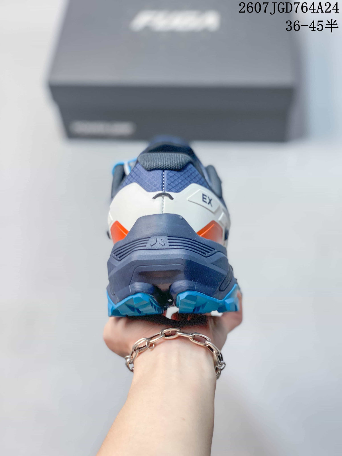 Rear view showing the navy heel, white upper panels, orange accents and blue outsole sections.