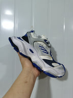 Side and front view of the Balenciaga Cargo sneakers showing the contrasting blue outsole and sculpted white midsole.