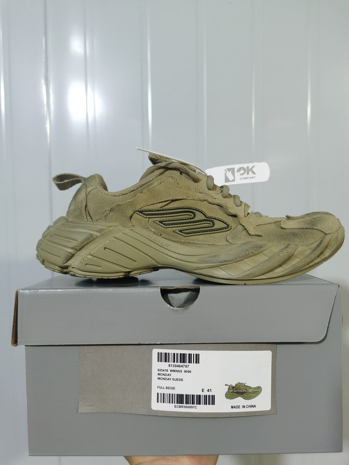 Beige 3K Company sneaker photographed on its box; the visible label reads Monday Suede, Full Beige, and E 41.