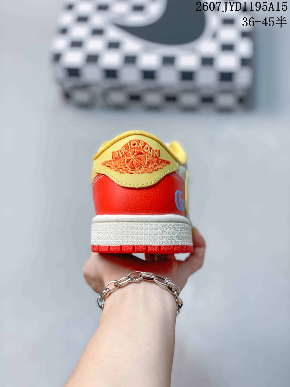 Rear view showing the red heel panel, yellow heel detail, white midsole, and red outsole.
