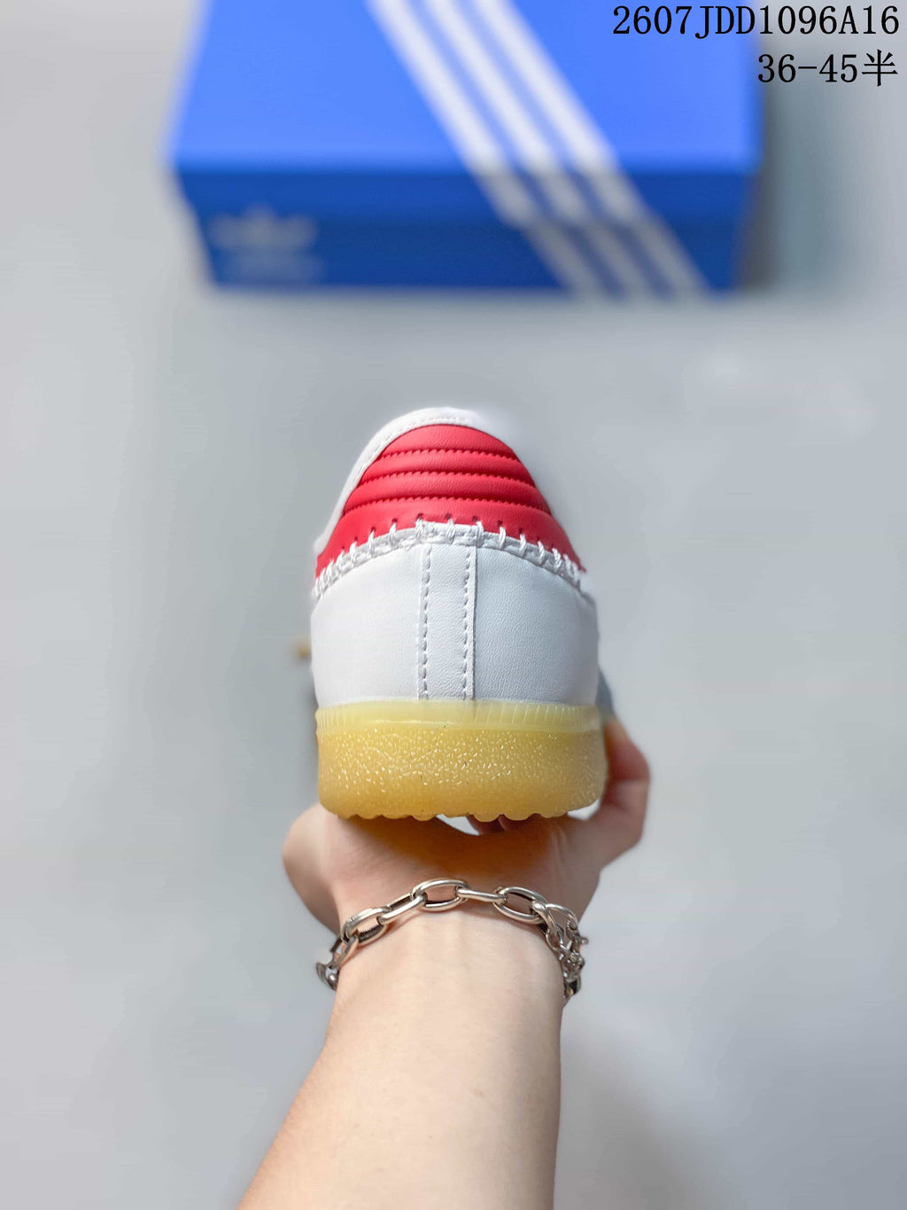 Rear view showing the white heel, red collar detail, and gum-colored outsole.