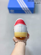 Rear view showing the white heel, red collar detail, and gum-colored outsole.
