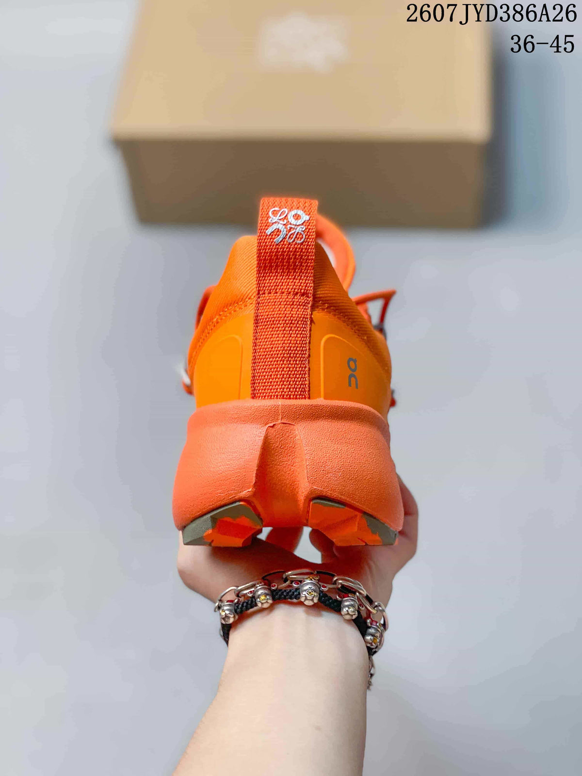Rear view of an orange sneaker showing the padded heel, pull tab, branded heel detail, and sculpted outsole.