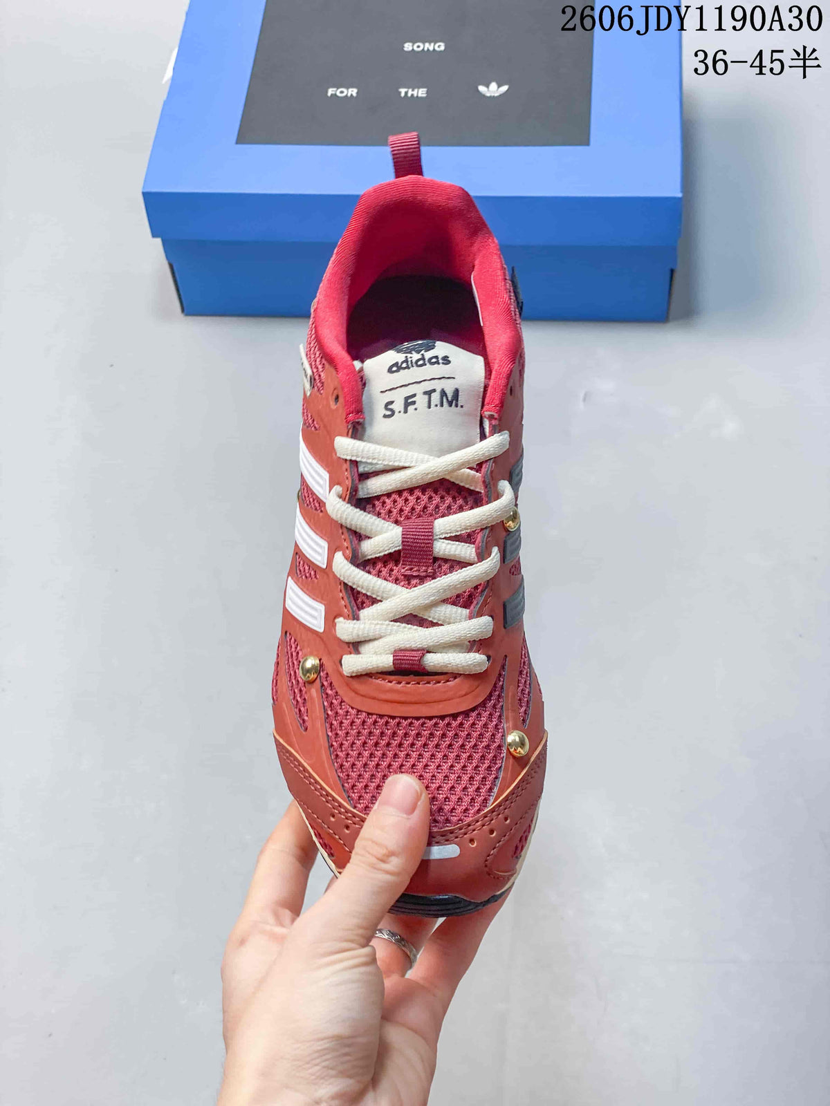 Front view showing the mesh toe, cream laces, and tongue branding.