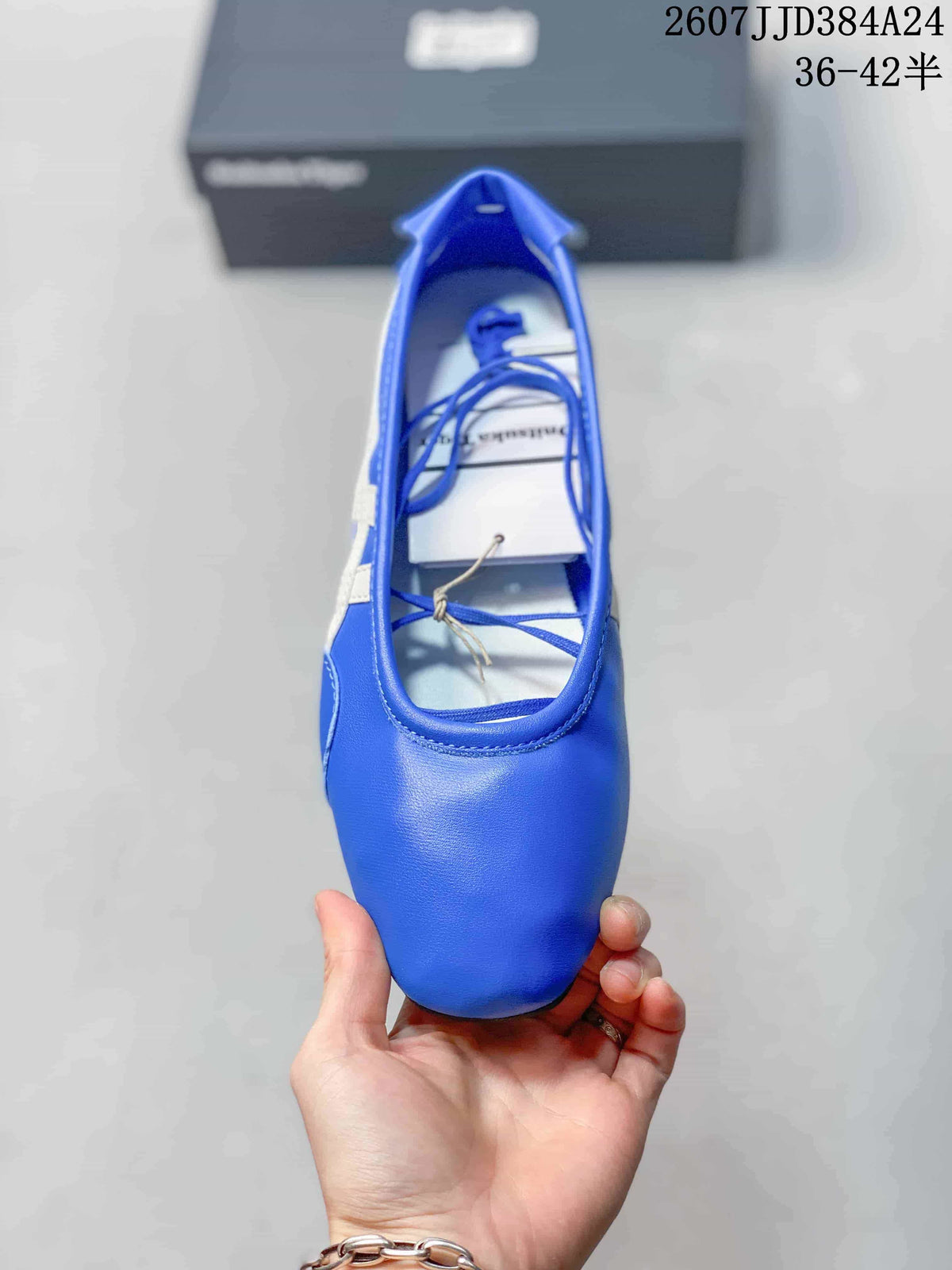 Top view of the blue shoe showing its rounded toe, strap detail, blue laces, and white insole.