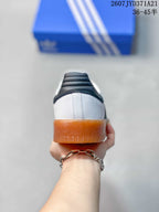 Rear view showing the white heel, black heel padding, and gum-colored outsole.