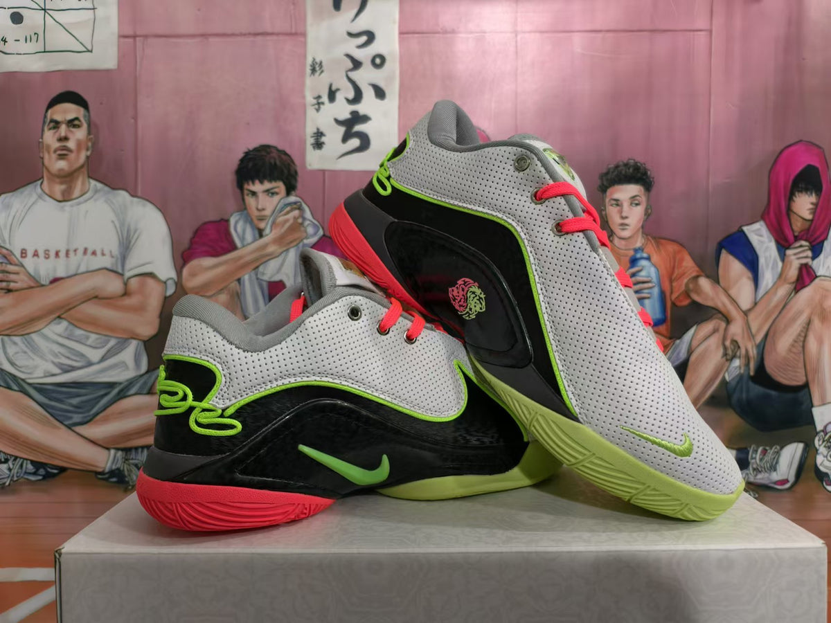 Two grey and black Nike basketball shoes shown from the side with bright contrasting details