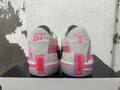 Rear view of pink, grey, and off-white Nike GT Cut 3 basketball shoes